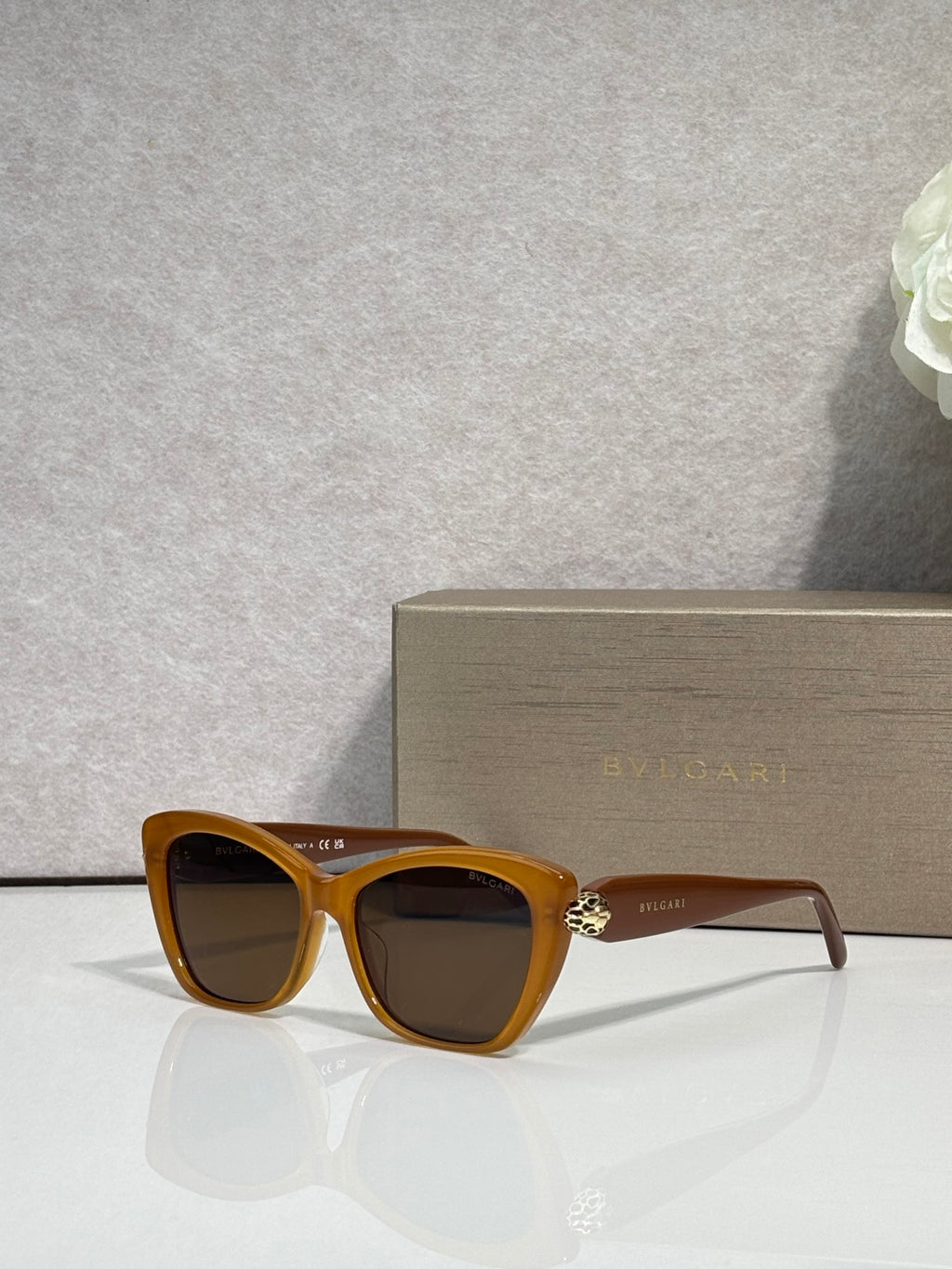 Bvlgari sunglasses, tortoiseshell frame with dark lenses and gold bridge emblem