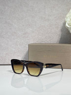 Bvlgari sunglasses, black frame with brown-tinted lenses and gold emblem detail