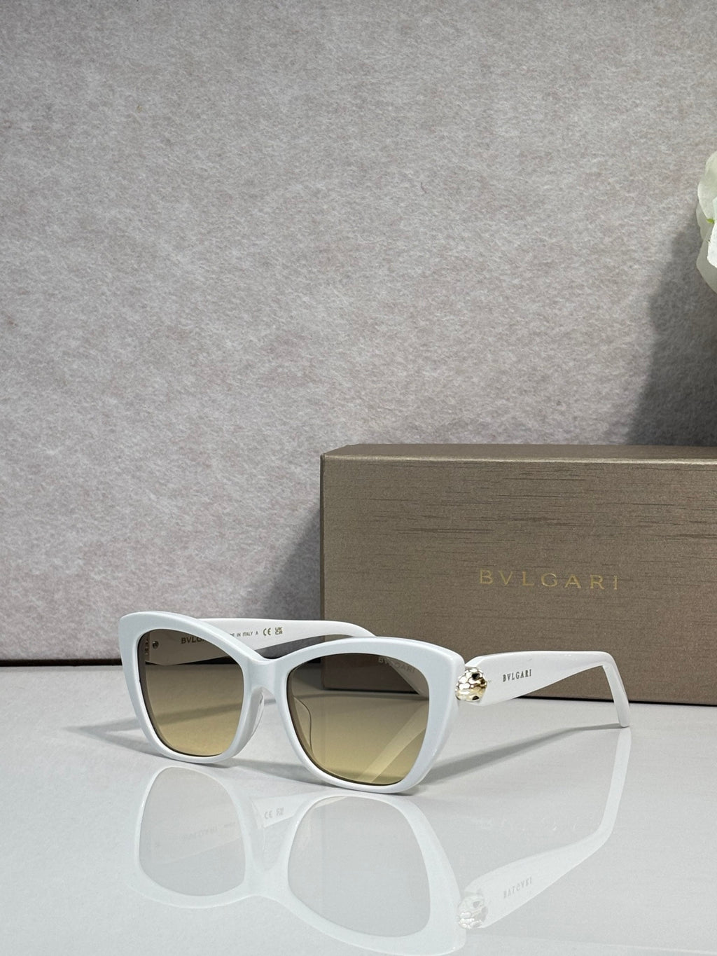 Bvlgari sunglasses, white frame with yellow-brown tinted lenses and gold hinge detail