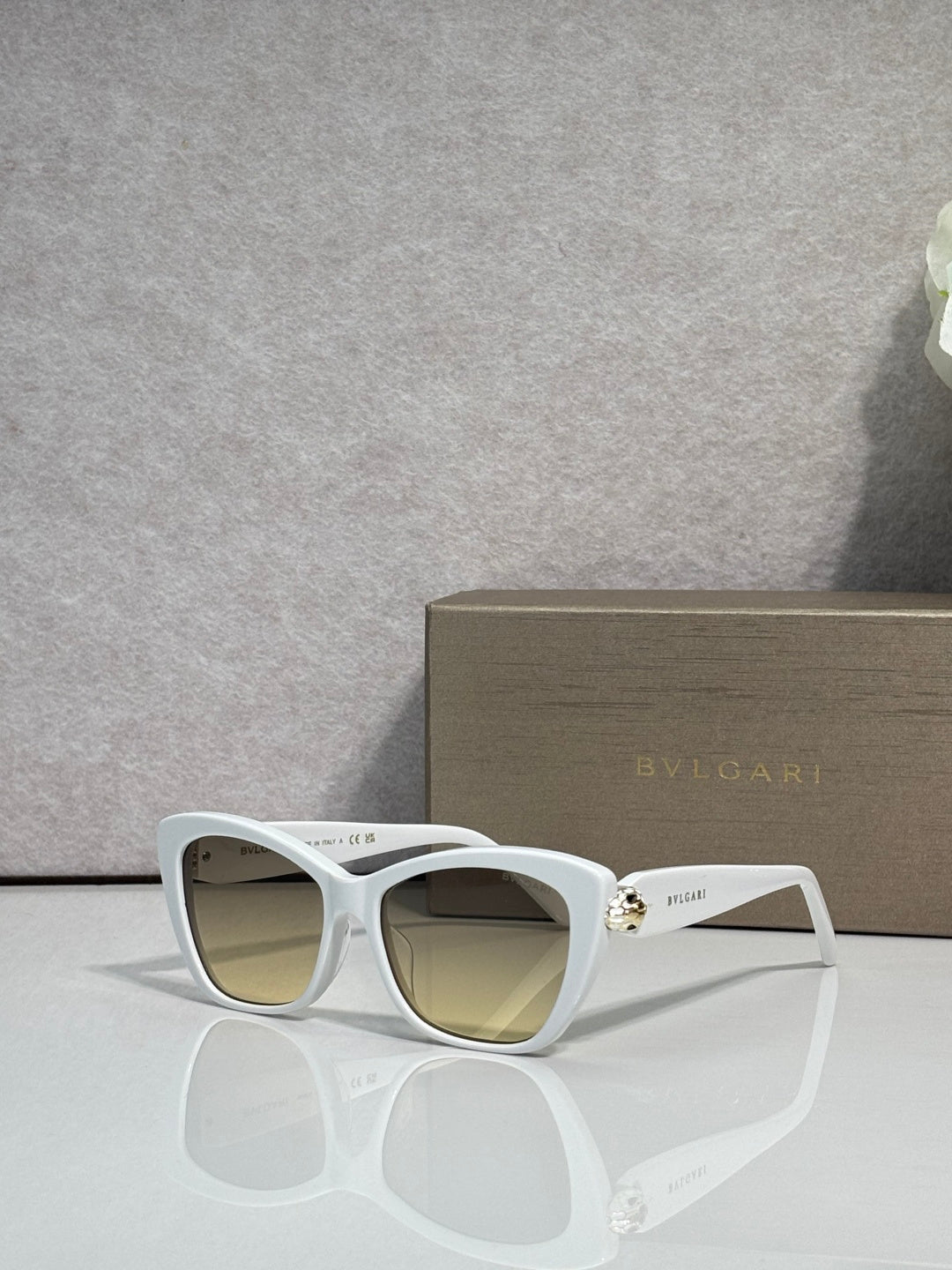 Bvlgari sunglasses, white frame with yellow-brown tinted lenses and gold hinge detail