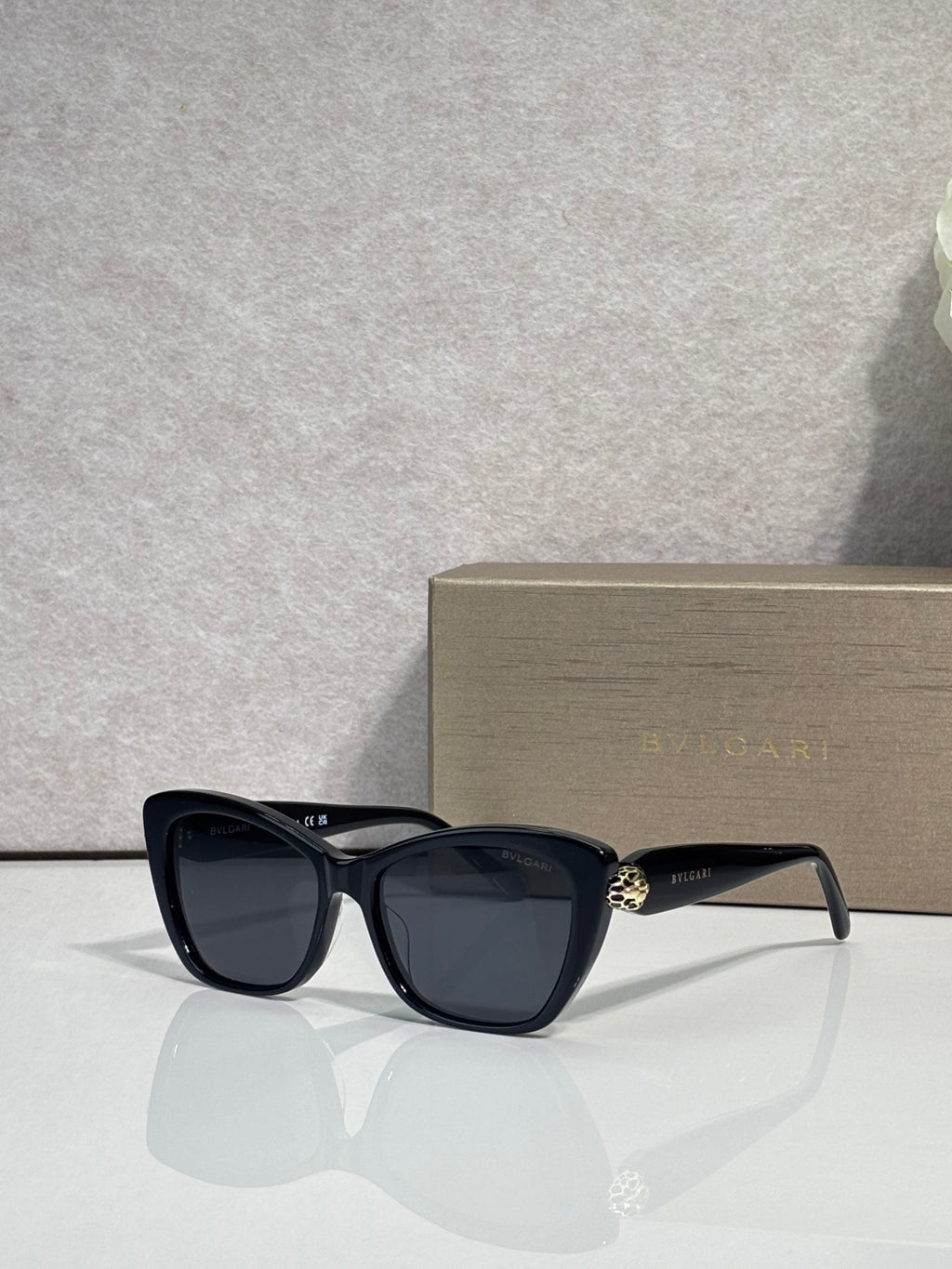 Bvlgari sunglasses, black frame with dark gray tinted lenses and gold side emblem