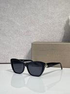 Bvlgari sunglasses, black frame with dark gray tinted lenses and gold side emblem
