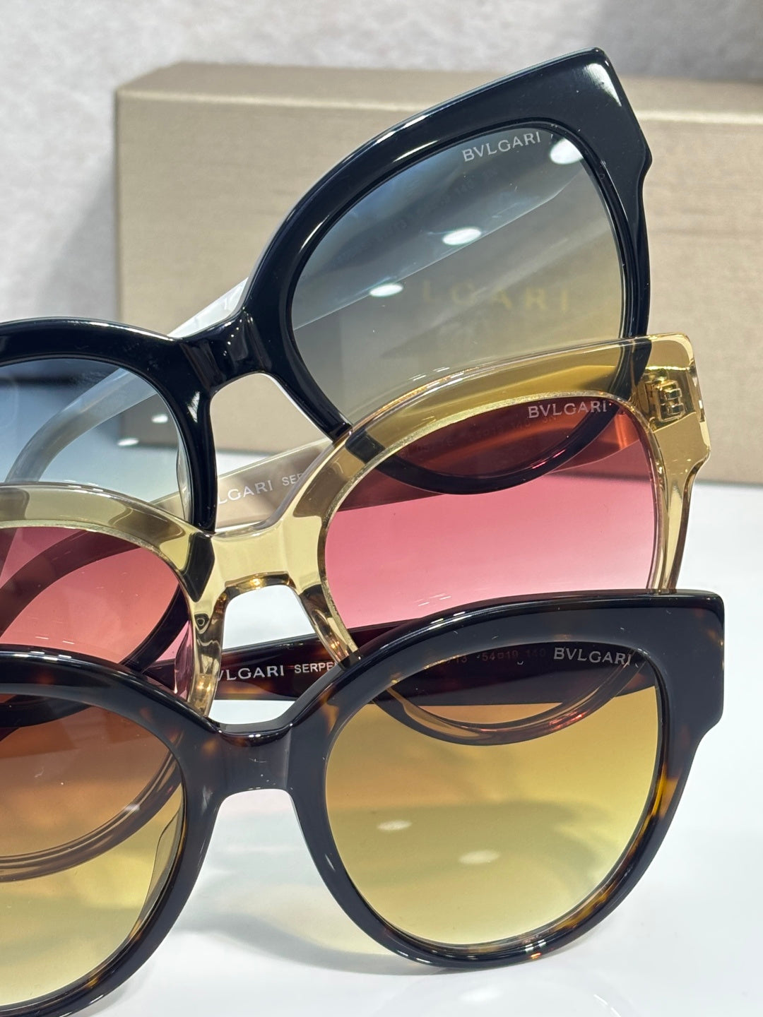 Bvlgari cat-eye sunglasses with layered dark and gold frames and tinted lenses