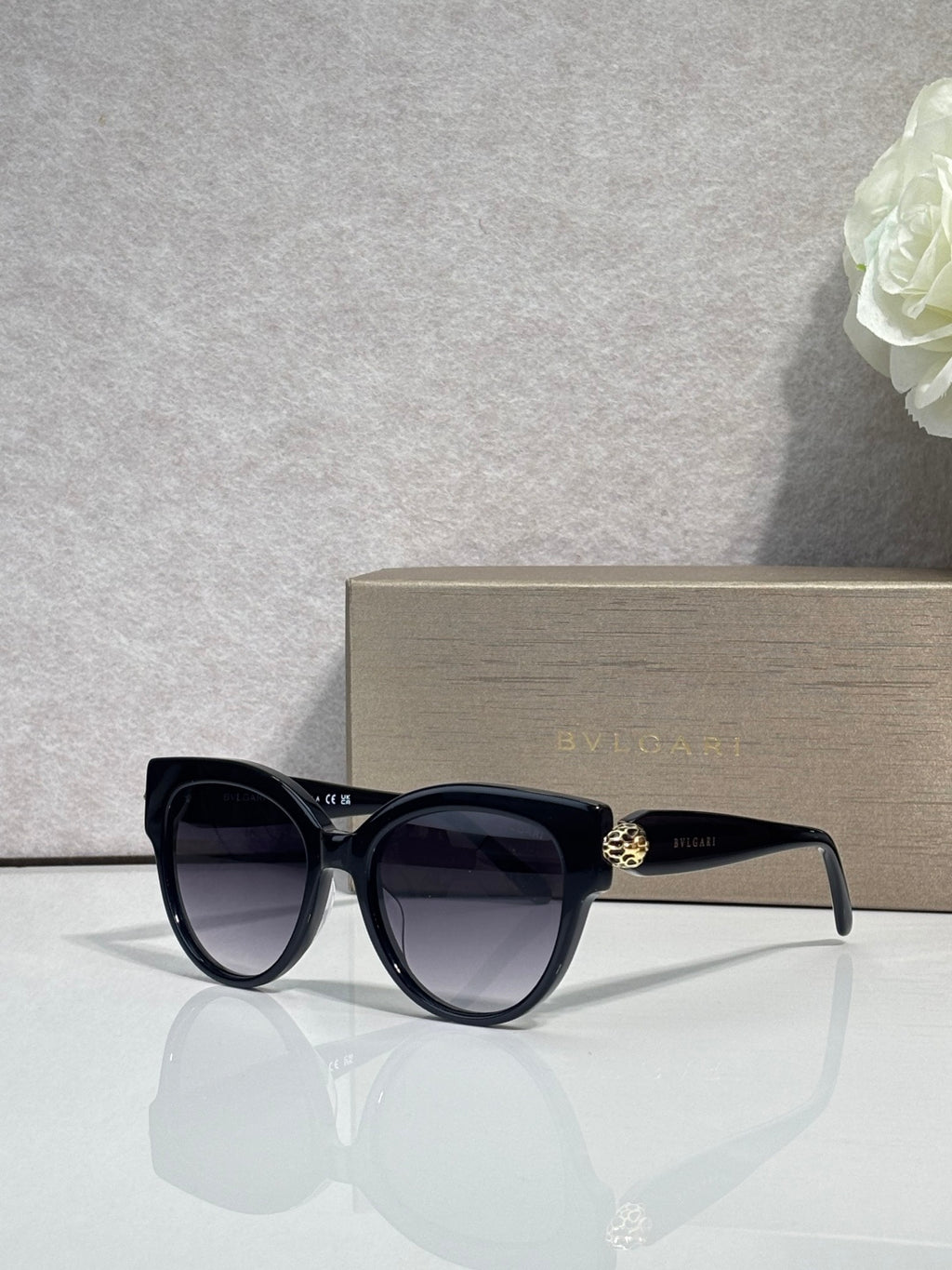 Bvlgari round cat-eye sunglasses with dark frame and black tinted lenses