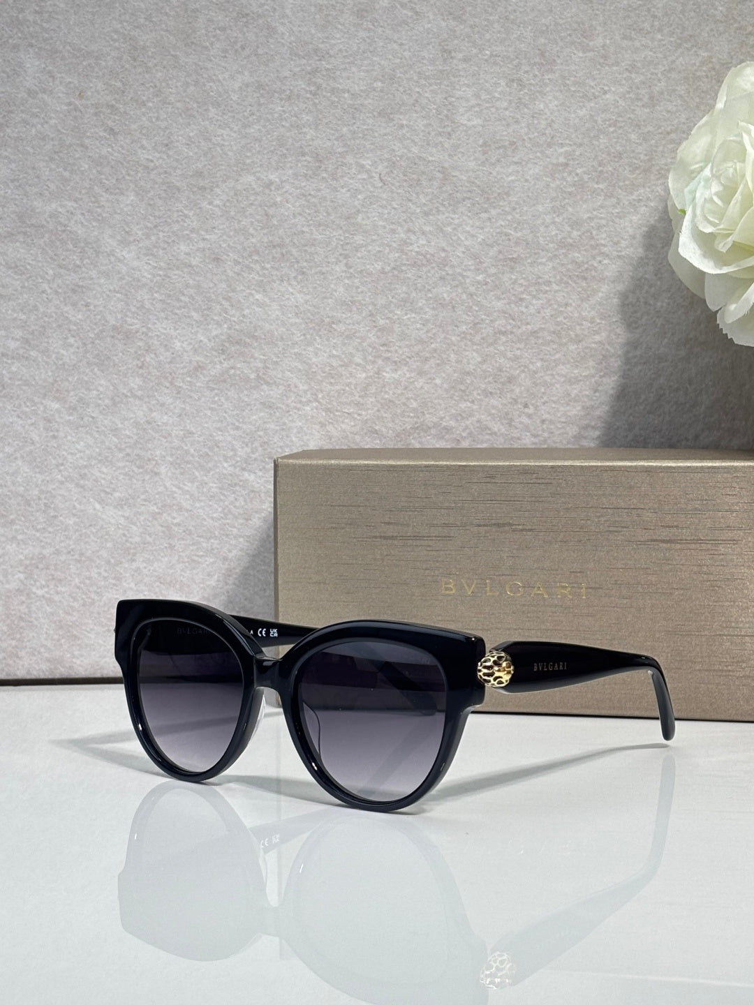 Bvlgari round cat-eye sunglasses with dark frame and black tinted lenses