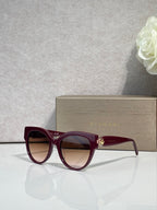 Bvlgari round cat-eye sunglasses with burgundy frame and dark red tinted lenses