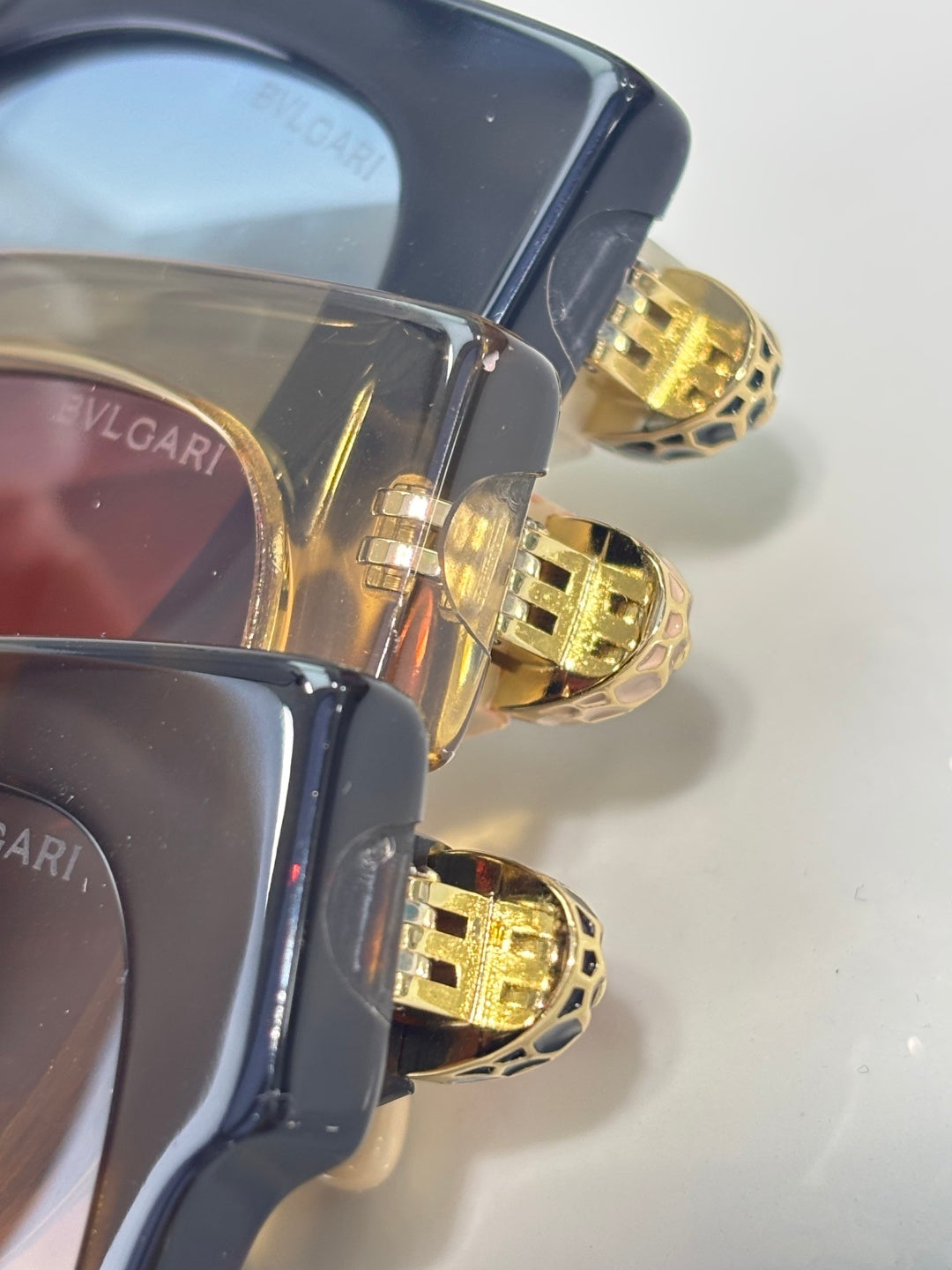 Bvlgari cat-eye sunglasses with gold medallion hinge and dark tinted lenses
