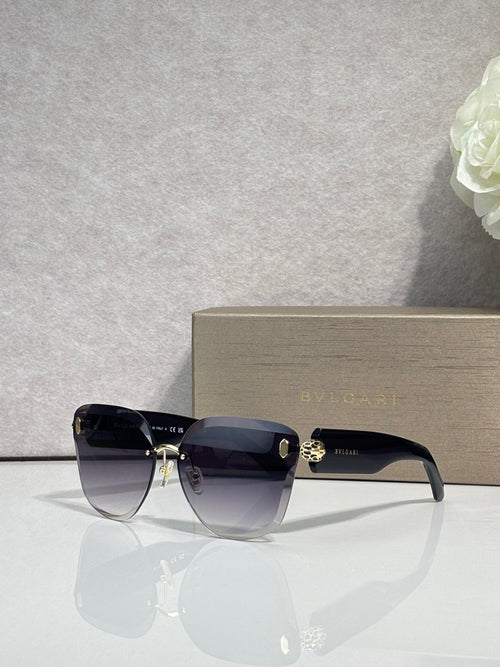 Bvlgari sunglasses with dark gradient lenses, black frame and gold emblem bridge