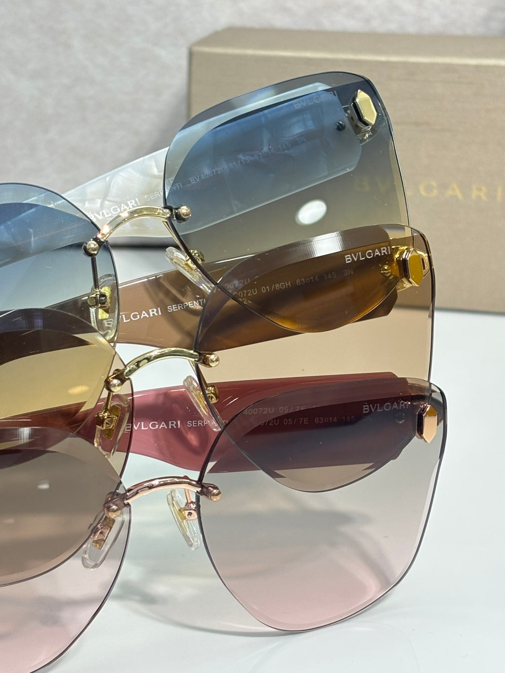 Sunglasses closeup with blue-tinted lenses and gold-tone hinge detail on frame