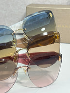 Sunglasses closeup with blue-tinted lenses and gold-tone hinge detail on frame