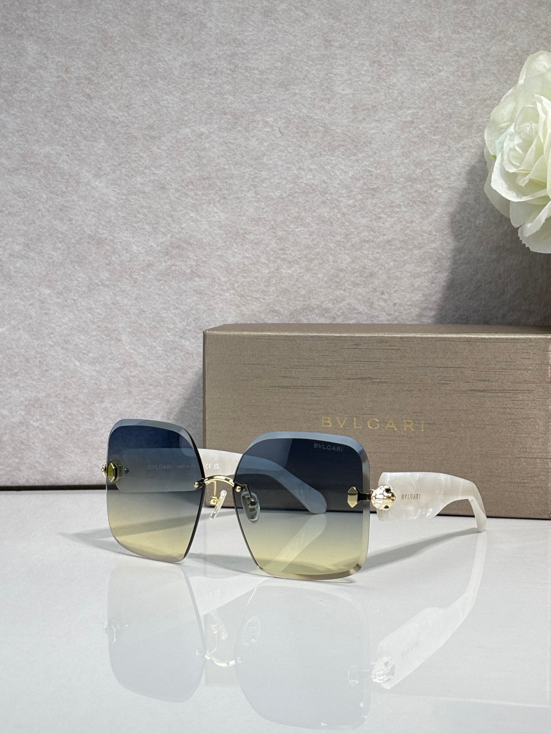 Bvlgari blue gradient sunglasses with gold-tone hinges and translucent frame arms