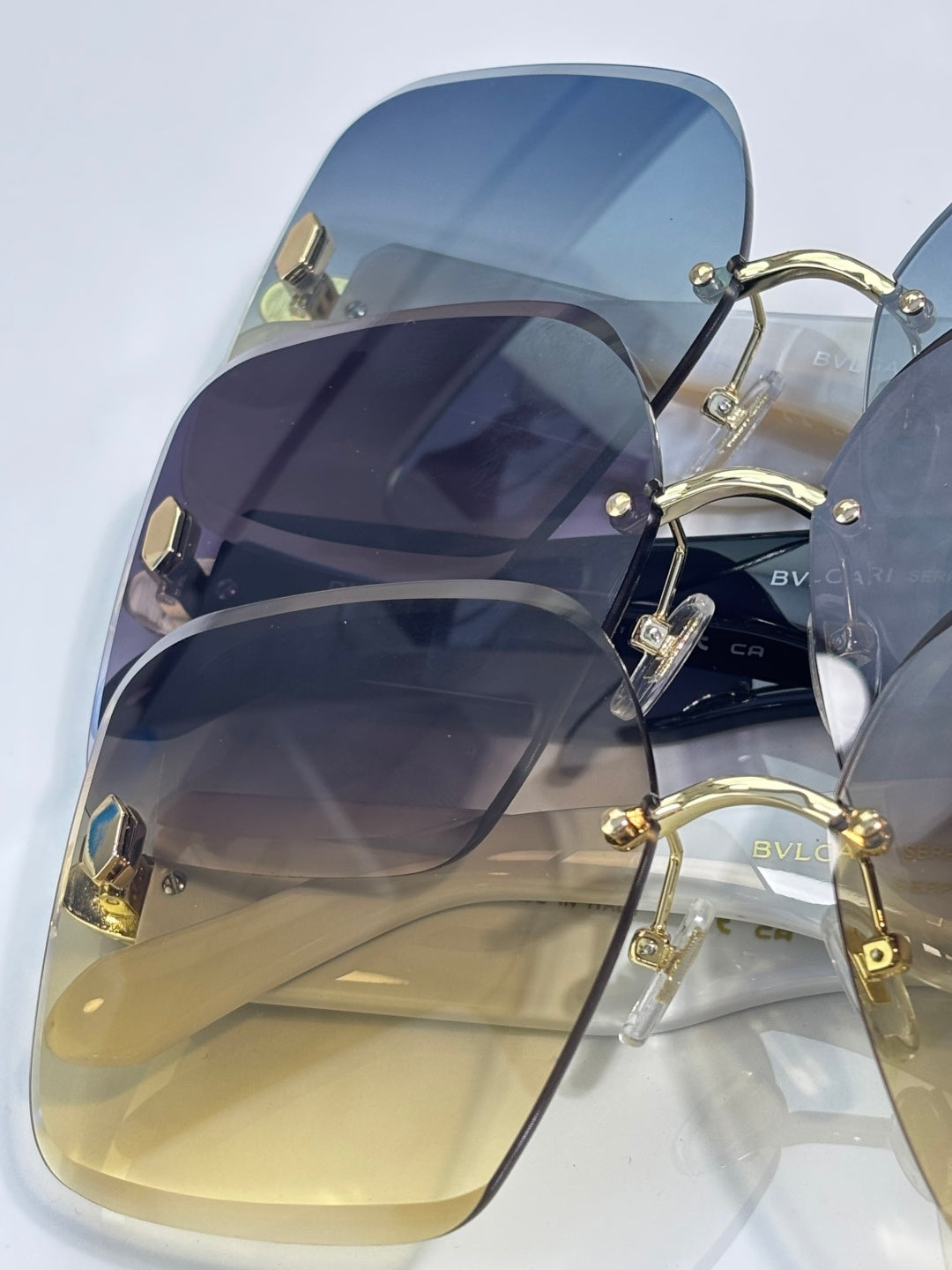Bvlgari light blue gradient sunglasses with gold-tone hardware and yellow-tinted lenses