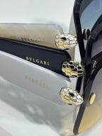 Bvlgari gold-tone snake motif sunglasses frame details on dark blue lenses