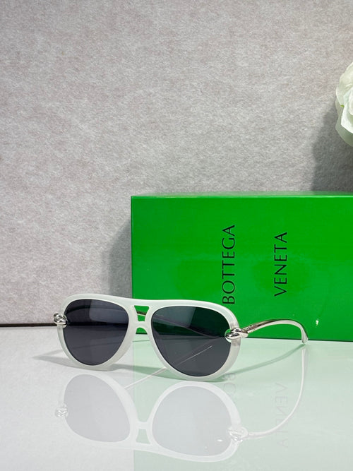 Bottega Veneta green-accent round sunglasses with dark lenses