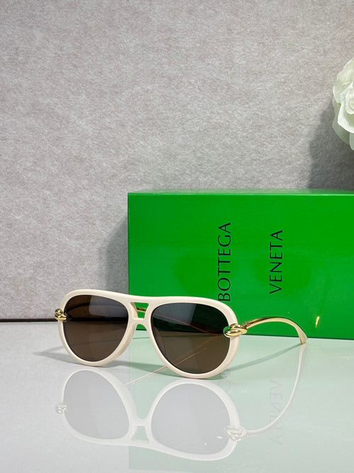 Bottega Veneta sunglasses with white frame, dark lenses, gold-tone detail