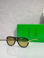 Bottega Veneta sunglasses with dark green frame, tinted lenses, gold-tone detail