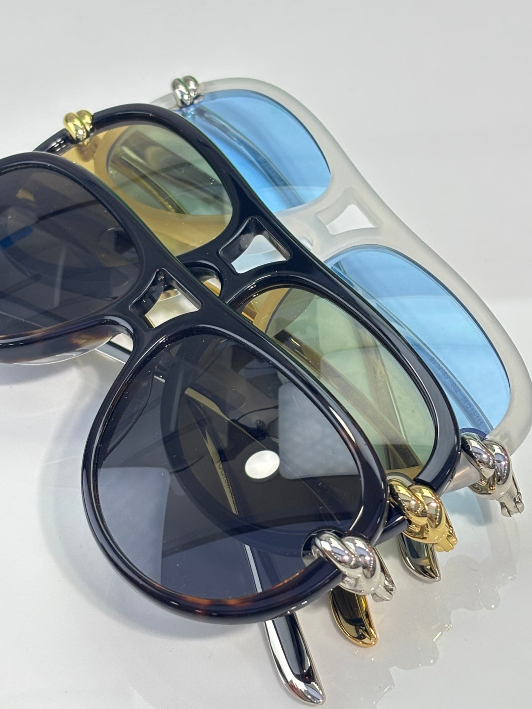Bottega Veneta sunglasses with dark navy frame, tinted lenses, gold hardware