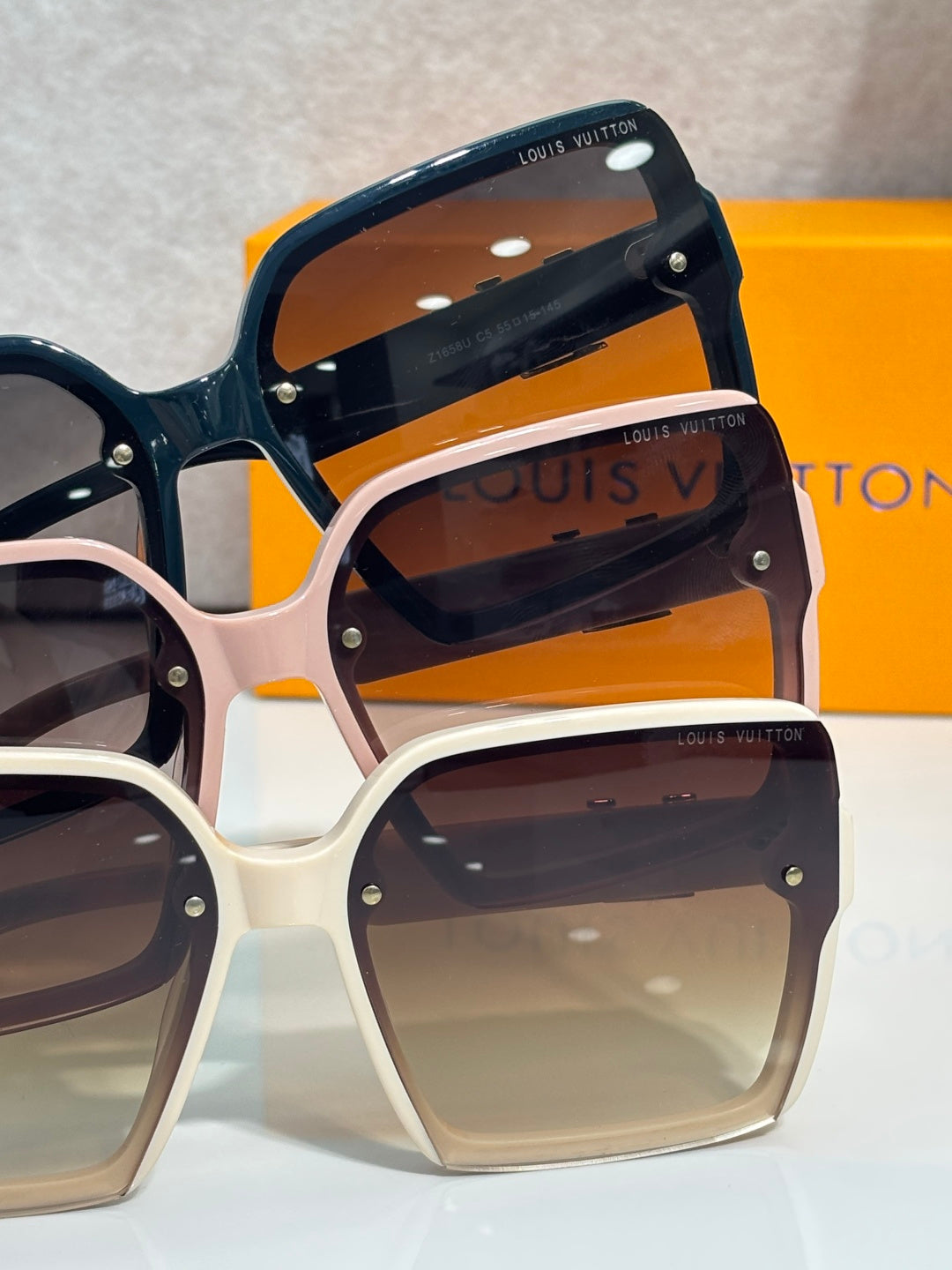 Louis Vuitton square sunglasses set with dark lenses and blue and white frames