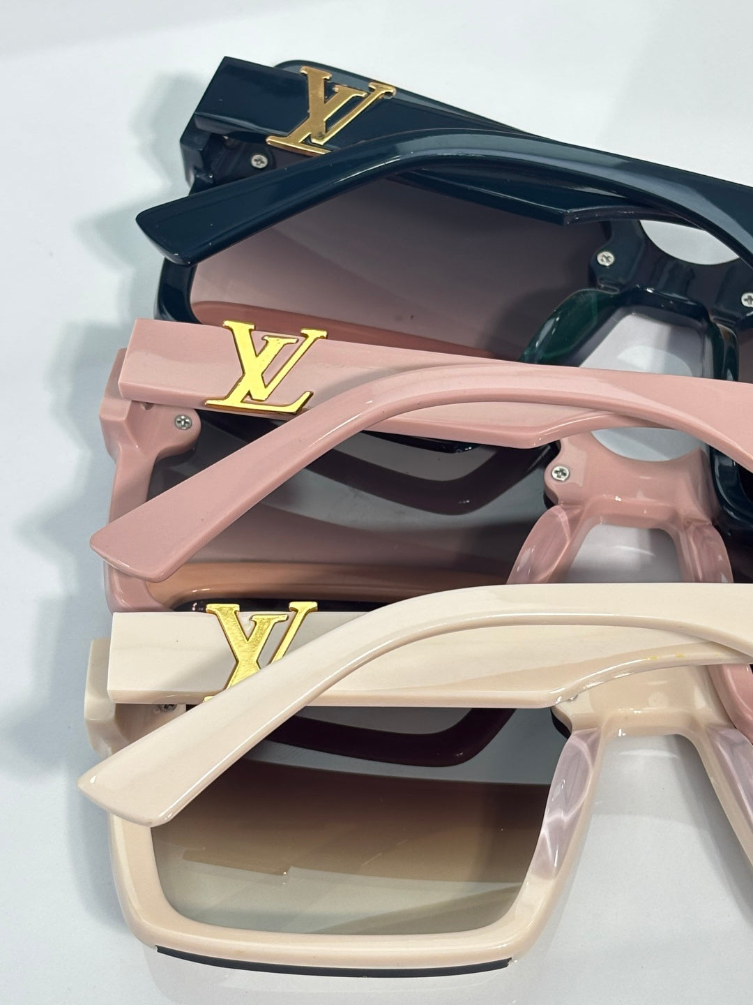 Louis Vuitton square sunglasses set with dark lenses and pink and cream frames, gold logos