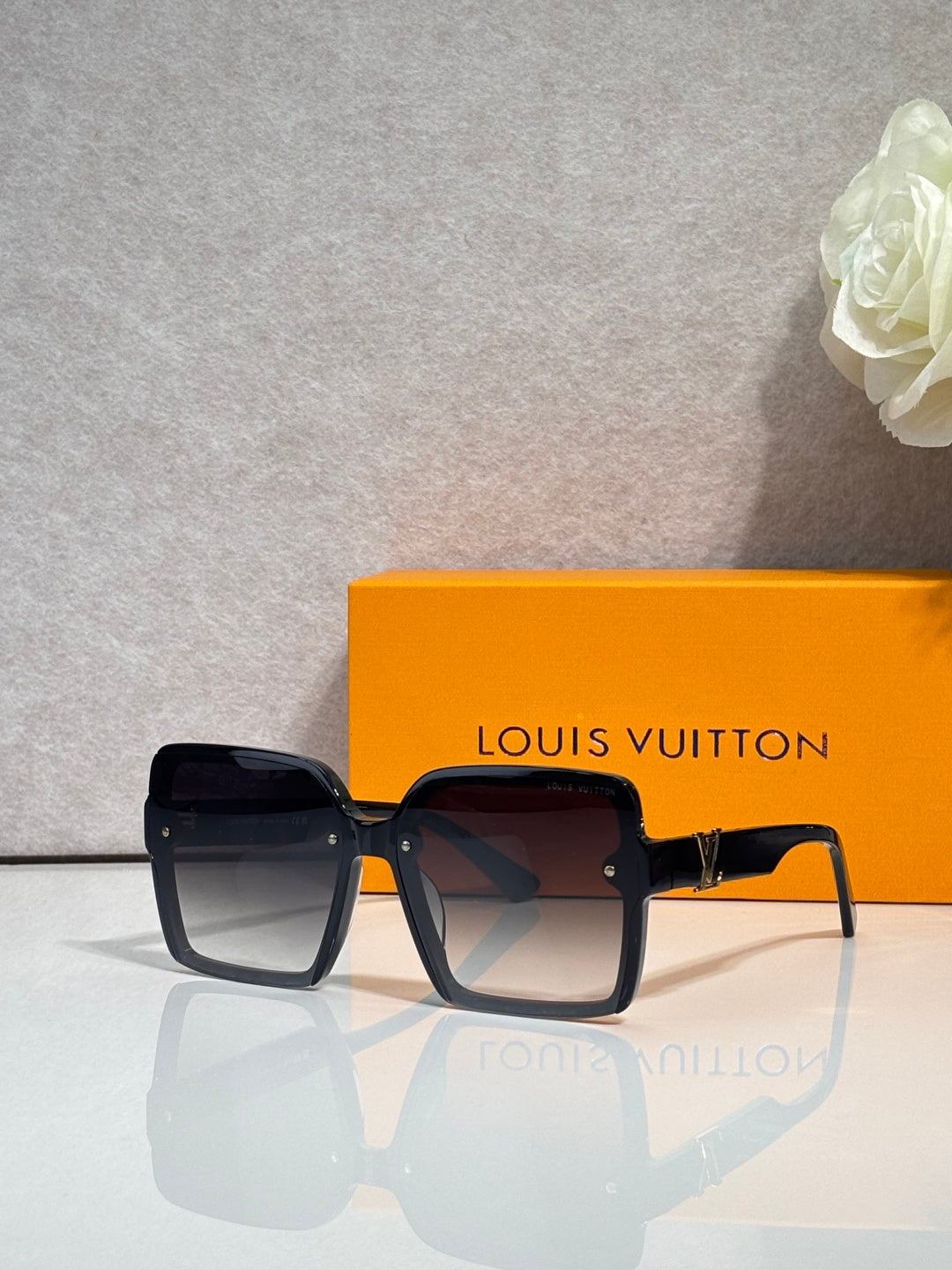 Louis Vuitton square sunglasses with dark lenses and black frame, logo on arms