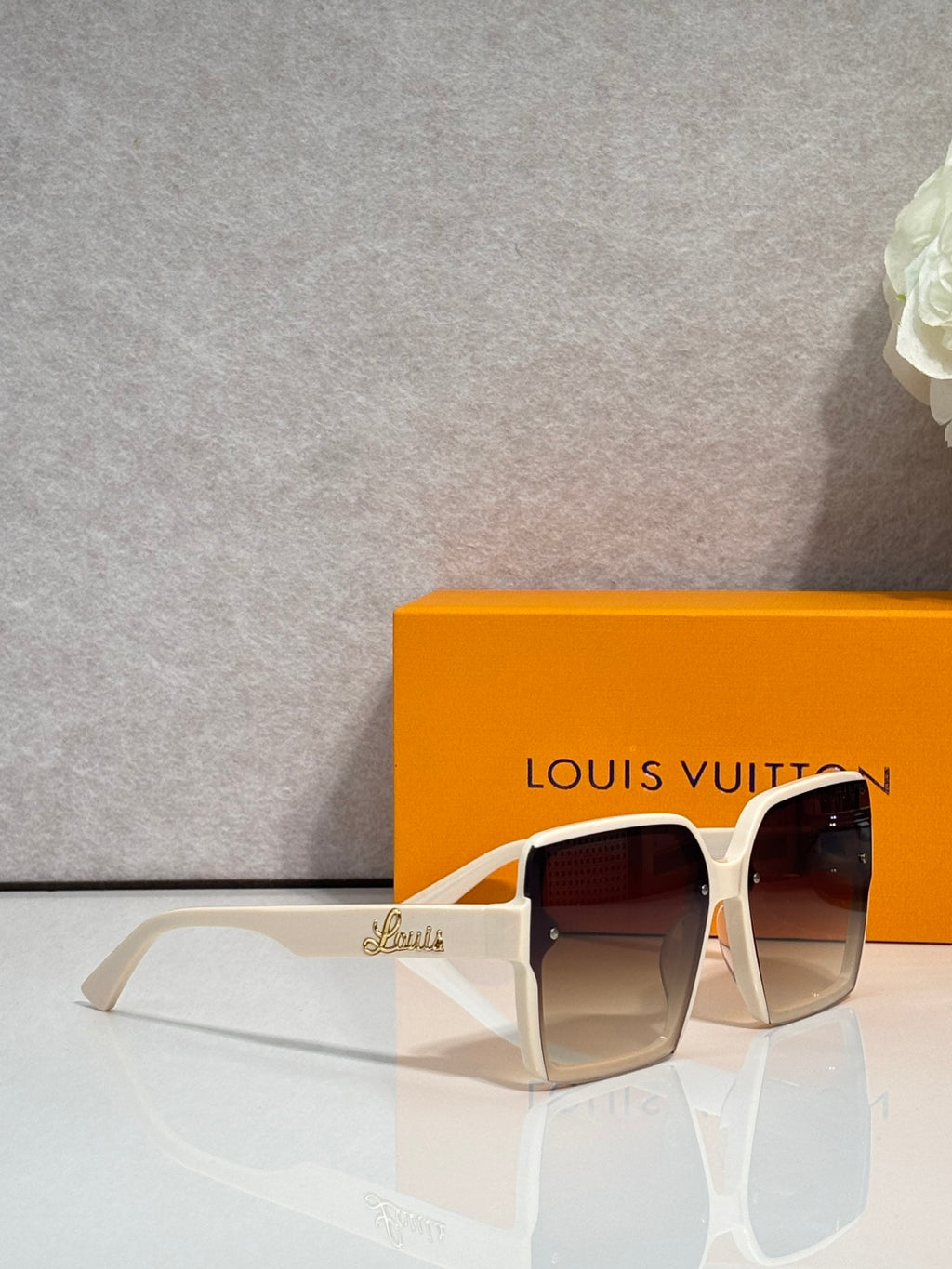Louis Vuitton square sunglasses with dark lenses and white frame, side view