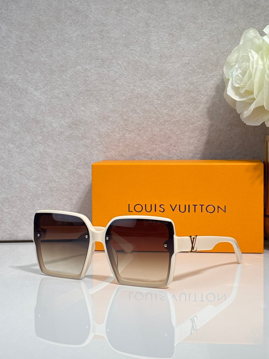 Louis Vuitton square sunglasses with dark lenses and white frame, logo on arms