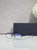 Round eyeglasses with blue-tinted lenses and black frame arms