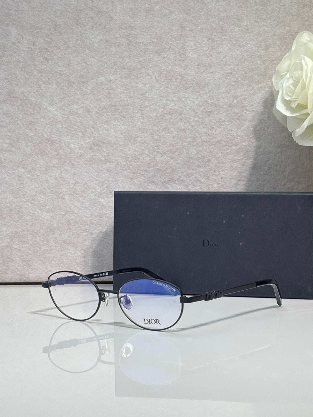 Round eyeglasses with blue-tinted lenses and black frame arms