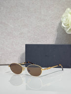 Round sunglasses with brown lenses and gold metal frame