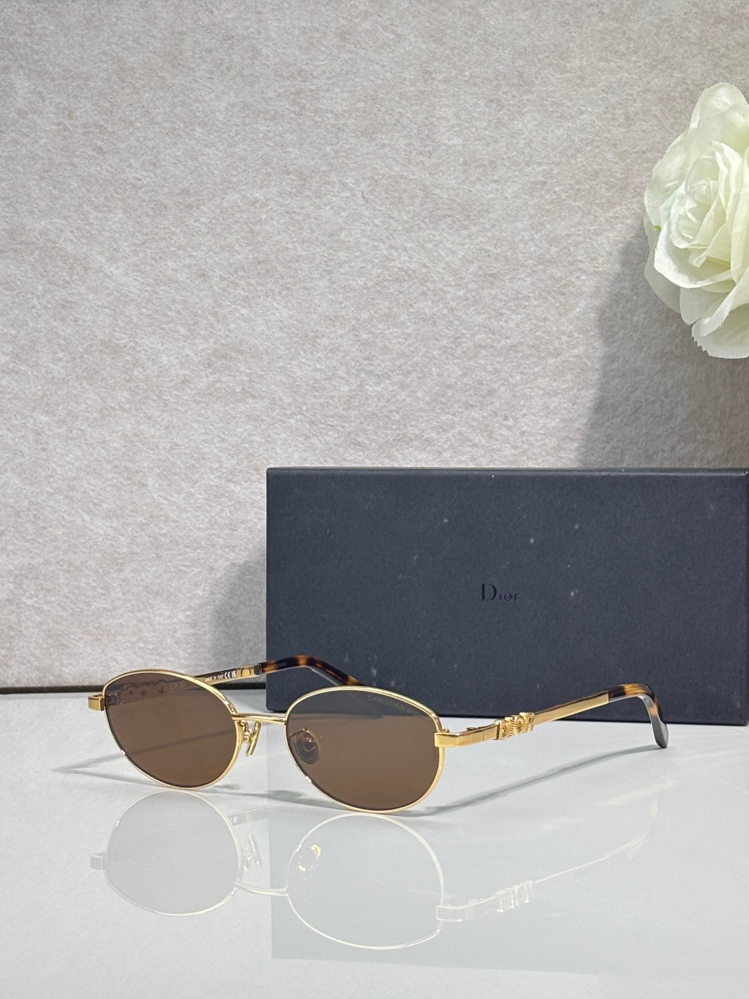 Round sunglasses with brown lenses and gold metal frame