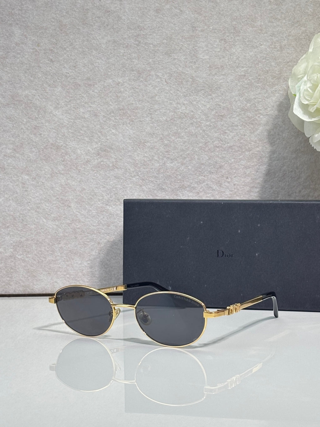 Round sunglasses with dark lenses and gold metal frame