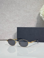 Round sunglasses with dark lenses and gold metal frame