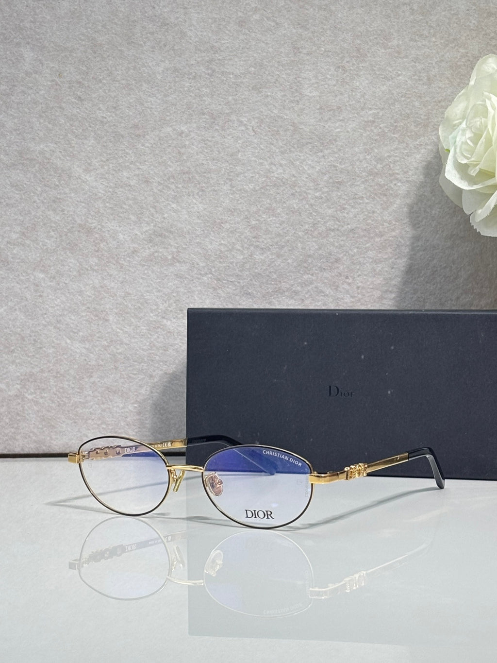 Round eyeglasses with blue-tinted lenses, gold metal frame and temples