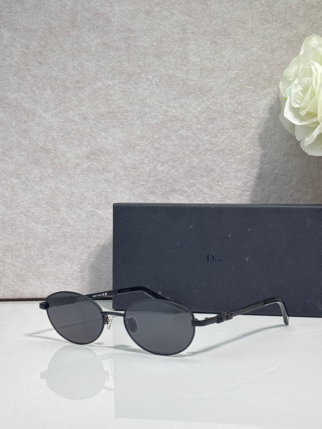 Round eyeglasses with blue monogram-pattern lenses and gold metal frame