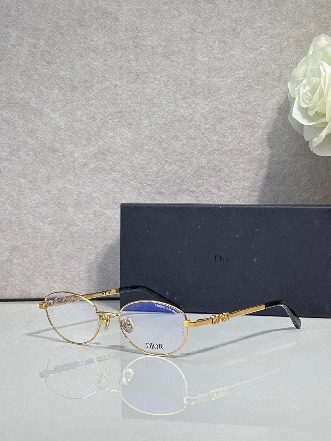 Round eyeglasses with gold frame and blue-tinted lenses