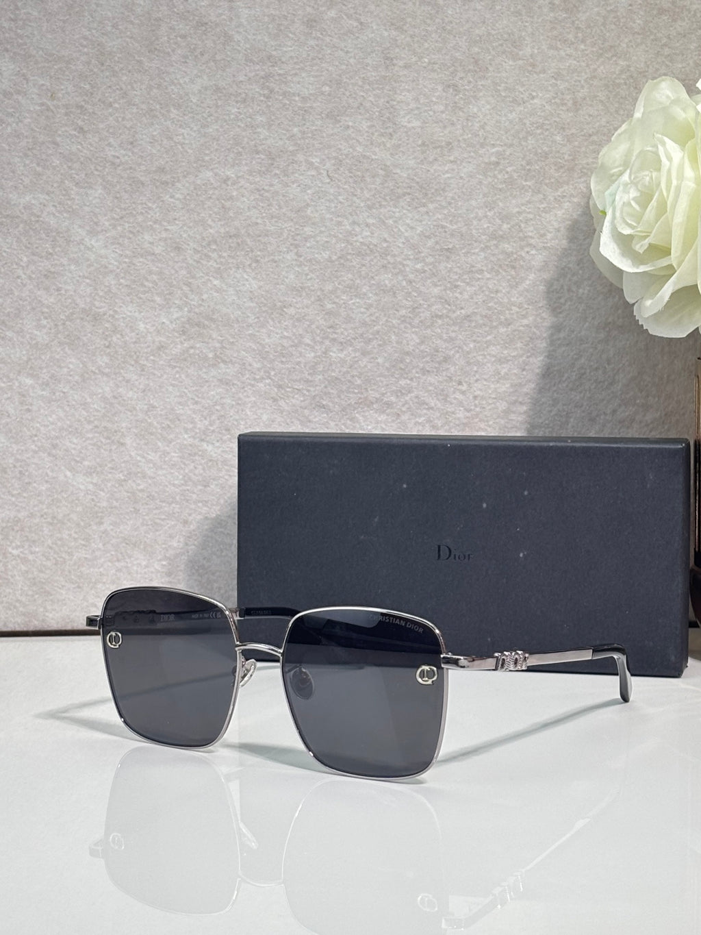 Dior sunglasses with dark lenses and metal frame, side profile