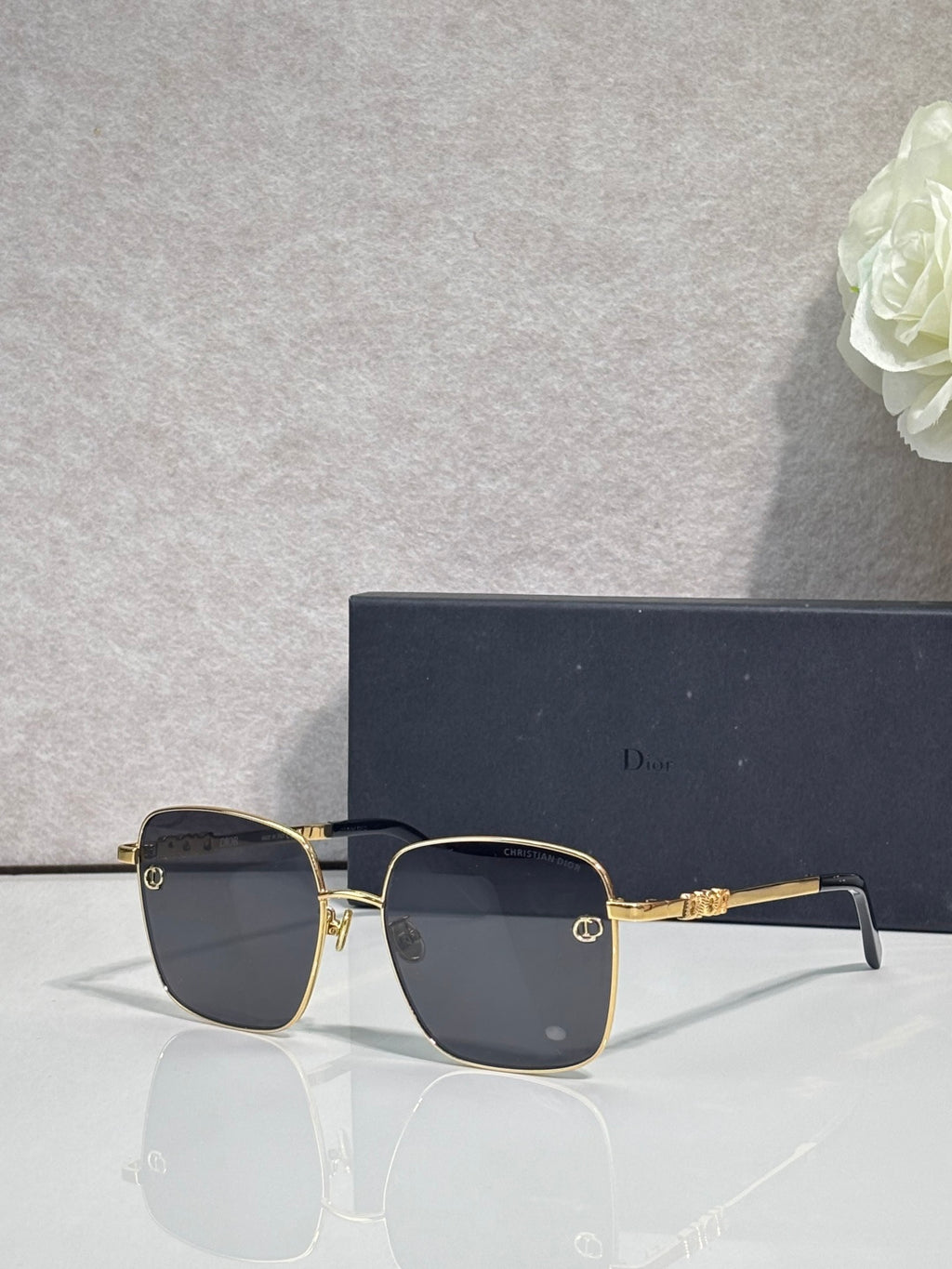 Dior sunglasses with dark lenses and gold-tone rectangular frame