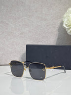 Dior sunglasses with dark lenses and gold-tone rectangular frame