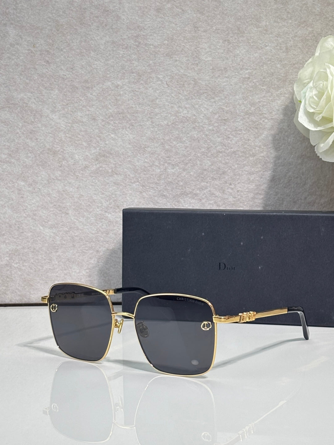 Dior sunglasses with dark lenses and gold-tone rectangular frame