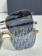 Dior eyeglasses close-up with navy Dior monogram lenses and gold-tone trim