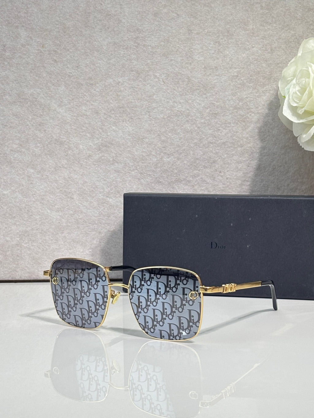 Dior eyeglasses with blue monogram patterned front and gold temples