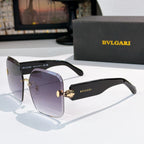 Bvlgari black sunglasses with gradient lenses and gold logo hinge medallion