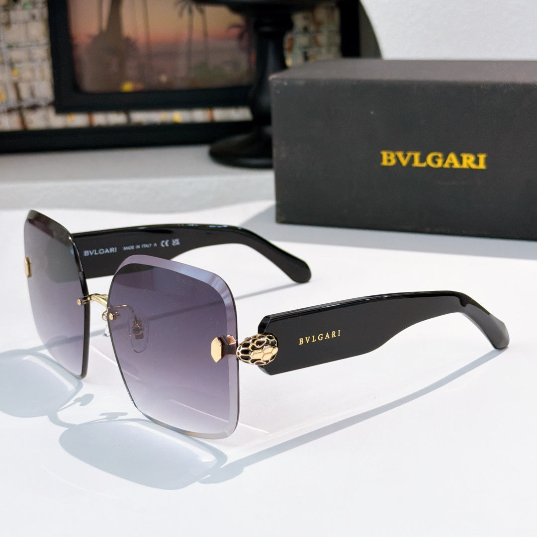 Bvlgari black sunglasses with gradient lenses and gold logo hinge medallion