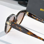 Sunglasses close-up of tortoiseshell temple with BVLGARI logo and gold hinge