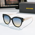 Sunglasses with black frames and light blue tinted lenses, BVLGARI side logo