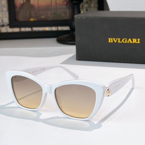 White cat-eye sunglasses with beige lenses and gold logo detail at the temple hinge