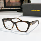 Tortoiseshell cat-eye eyeglasses with clear lenses and gold logo detail at the temple hinge