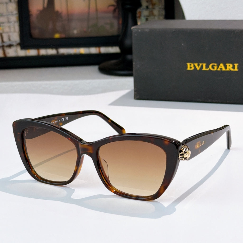Tortoiseshell cat-eye sunglasses with brown lenses and gold logo detail at the temple hinge