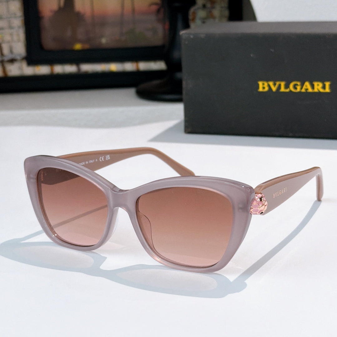 Light pink cat-eye sunglasses with pink-tinted lenses and gold logo detail at the temple hinge