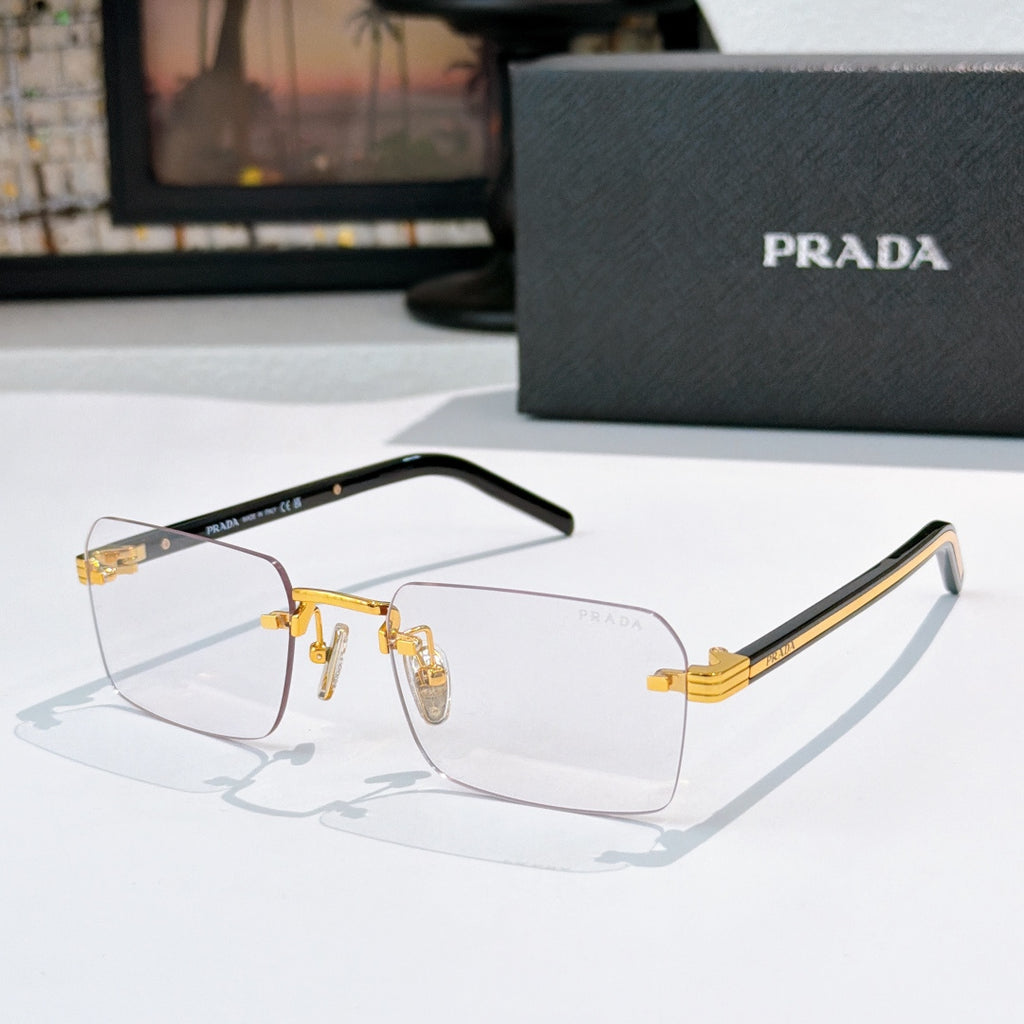 Prada eyeglasses with clear lenses and gold metal frame, black temple arms